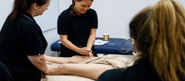 Students conducting remedial massage training